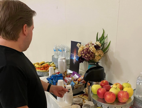 A guest enjoys the healthy snack table.